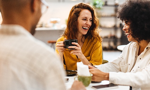 Group of friends smiling at cafe
