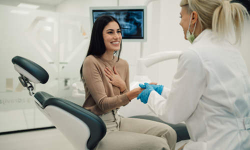 Smiling patient shaking dentist's hand