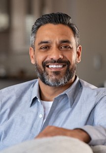 a person holding their cheek due to tooth pain