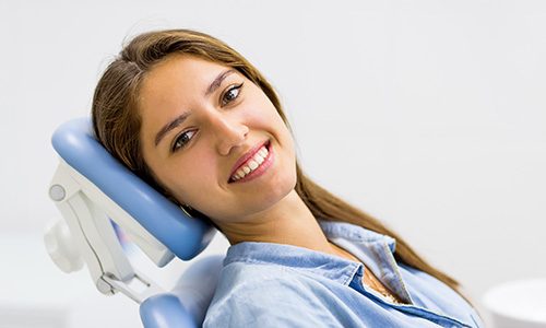 Smiling patient leaning back in treatment chair