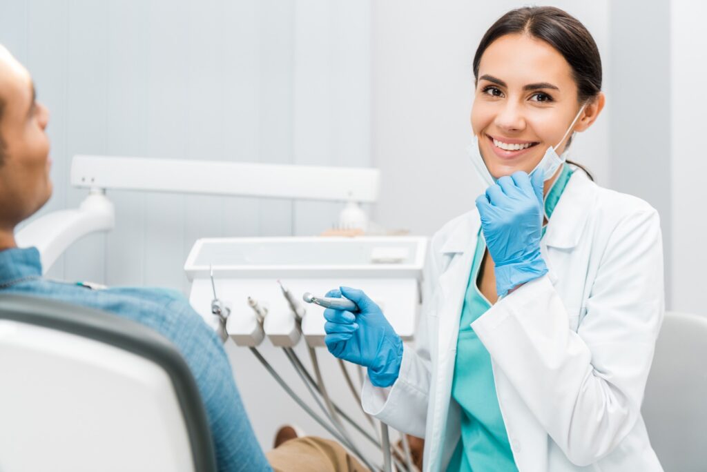 Dentist smiling at patient's dental exam