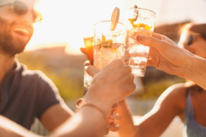 a group of friends smiling and drinking 